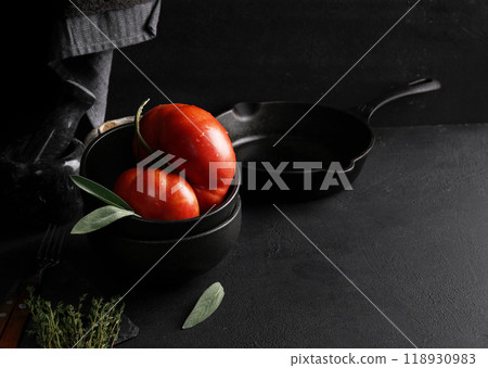 Big red tomato in black bowl. top view, copy space 118930983