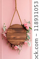 round wooden blank sign with flowers hanging on rope, on pink background, copy space 118931053
