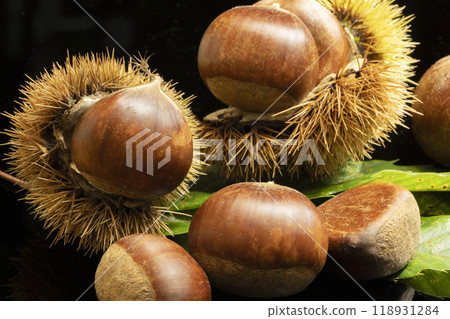 Shelled chestnuts on a black background Shelled chestnuts on a black background 118931284