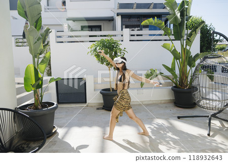 A Woman Posing Outdoors in a Beautiful Tropical Setting that Captures Her Joyful Spirit A Woman Posing Outdoors in a Beautiful Tropical Setting that Captures Her Joyful Spirit 118932643