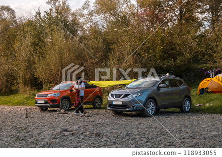 Camping Setup by the Riverbank with Cars Camping Setup by the Riverbank with Cars 118933055