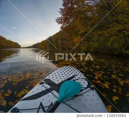 Paddleboarding on a Serene Autumn Lake 118933063