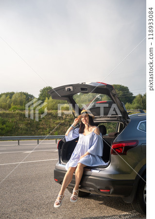 Woman Enjoying a Sunny Day by Her Car Woman Enjoying a Sunny Day by Her Car 118933084