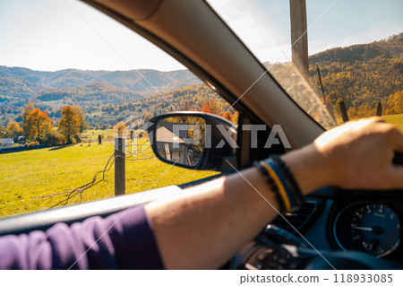 Man Driving Through Autumn Landscape Man Driving Through Autumn Landscape 118933085