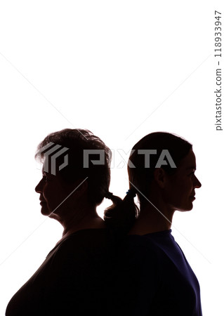 Silhouette elderly woman opposite young woman, mother and daughter - isolate 118933947