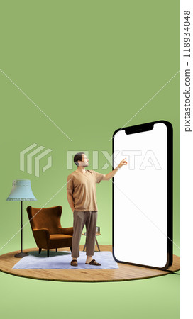 Man standing alone in simple room, pointing at giant 3D model of phone with blank screen. Use of mobile apps for efficiency and fast online services. Man standing alone in simple room, pointing at giant 3D model of phone with blank screen. Use of mobile apps for efficiency and fast online services. 118934048