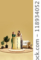 Cozy couple leaning on large credit card in warm, minimalistic setting, representing financial comfort and home improvements through digital banking. 118934052