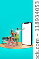 Family dressed for vacation, pointing at giant 3D model of phone with blank screen, representing online travel booking, online payment, services. Summer vibe. 118934053