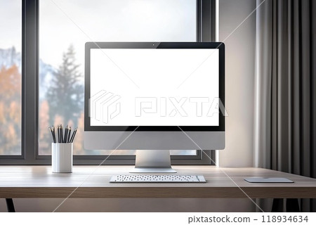 A modern workspace featuring a blank computer screen, desk, and natural light through large windows, perfect for creativity. 118934634