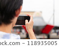 A person taking a photo using a smartphone 118935005