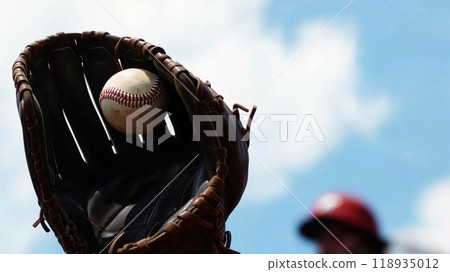 baseball glove catches ball against bright blue sky, capturing excitement of game. scene evokes sense of anticipation and joy in sports baseball glove catches ball against bright blue sky, capturing excitement of game. scene evokes sense of anticipation and joy in sports 118935012