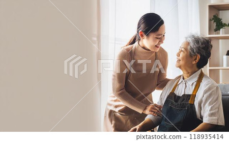 Seniors and caregivers relaxing in the living room 118935414