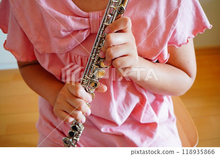 The hands of an elementary school girl holding a flute The hands of an elementary school girl holding a flute 118935866
