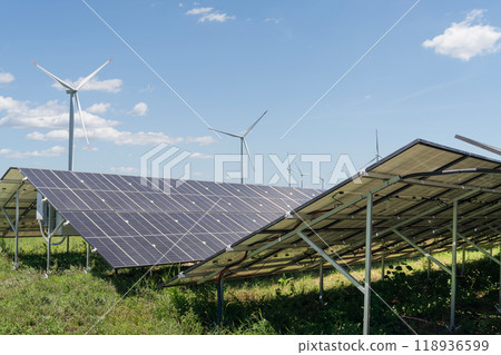 Solar panels and wind turbines on a field. Sustainable energy Solar panels and wind turbines on a field. Sustainable energy 118936599