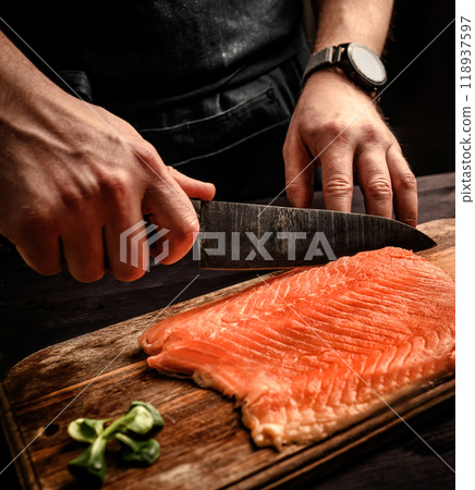 Chief cooking salmon for dinner, cutting red fish 118937597