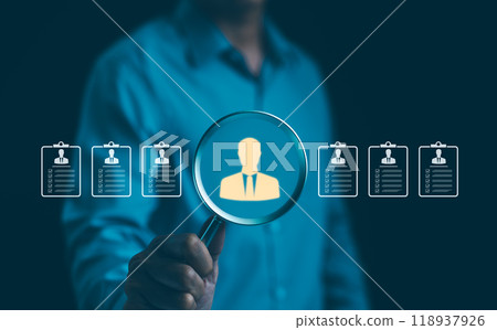 HR, Human Resources Recruitment Concept. A person holds a magnifying glass over a holographic resume, representing the concept of human resources, recruitment, and headhunting in a business setting. 118937926