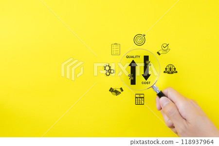 Effective business concept. Quality increase and cost reduction. Hand holds a magnifying glass over icons representing quality control increase, cost reduction, business efficiency, and optimization. Effective business concept. Quality increase and cost reduction. Hand holds a magnifying glass over icons representing quality control increase, cost reduction, business efficiency, and optimization. 118937964