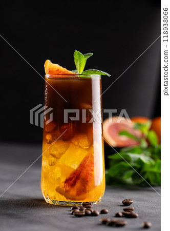 Coffee with orange juice (bumble) in a tall glass with ice and mint on a dark background Coffee with orange juice (bumble) in a tall glass with ice and mint on a dark background 118938066