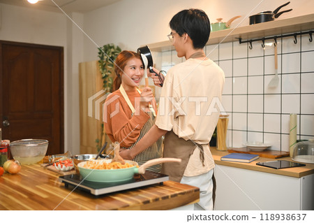 Loving asian couple couple enjoying time together in kitchen. People and domestic life concept Loving asian couple couple enjoying time together in kitchen. People and domestic life concept 118938637