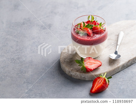 Strawberry and cream panna cotta in glass with fresh berries on a marble board on a light background Strawberry and cream panna cotta in glass with fresh berries on a marble board on a light background 118938697