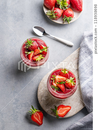 Strawberry and cream panna cotta in glasses with berries on a marble board on a light background Strawberry and cream panna cotta in glasses with berries on a marble board on a light background 118938698