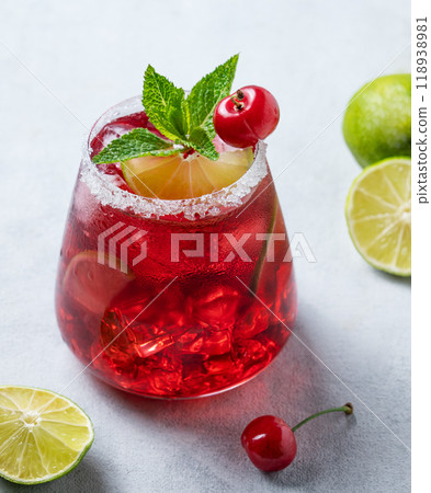 Cherry-lime mojito cocktail with mint, lime and ice on a light background with fresh berries Cherry-lime mojito cocktail with mint, lime and ice on a light background with fresh berries 118938981