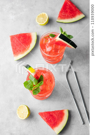 Mojito cocktail with watermelon, lime, ice and mint in a two glasses on a light background 118939000