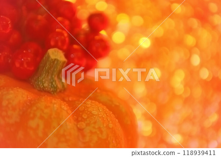 Realistic halloween pumpkin against a glowing bokeh background for festive atmosphere 118939411