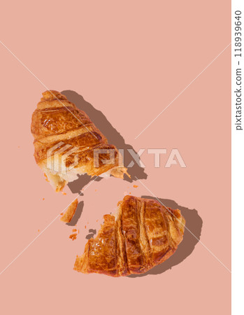 Flat lay of fresh broken croissant on beige background with shadow. Flat lay of fresh broken croissant on beige background with shadow. 118939640