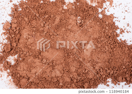 Scattered brown eyeshadow on a white background. Eye shadow texture 118940184