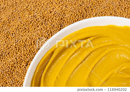 Mustard sauce and dry mustard seeds, top view. Mustard sauce and dry mustard seeds, top view. 118940202