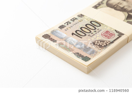 A stack of 10,000 yen bills on a white background A stack of 10,000 yen bills on a white background 118940560