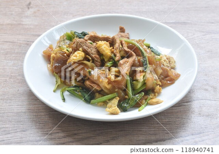 stir fried large rice noodles with slice fermenting pork and Chinese kale dressing black sweet soybean sauce on plate 118940741
