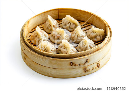 A bamboo steamer filled with dumplings sitting on top of a table 118940862