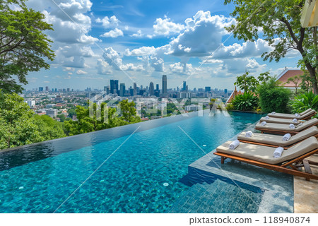 A swimming pool with lounge chairs and a view of the city 118940874