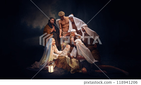 Traditional Christmas Nativity scene featuring Mary, Joseph, baby Jesus, shepherds and angel, symbolizing the birth of Jesus Christ 118941206