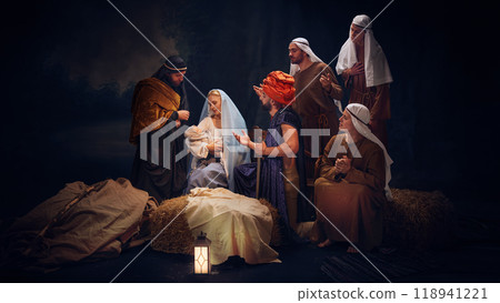 The wise men and shepherds gathering around Mary and baby Jesus, offering gifts and prayers. Holiness of sacred night. 118941221
