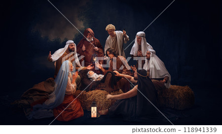 The Holy Family and wise men gather in prayer around baby Jesus. Hope and the light of salvation on Christmas night. Holy moment 118941339