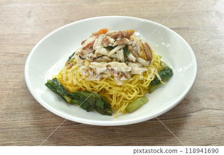 Chinese egg yellow noodles topping crab meat on plate 118941690