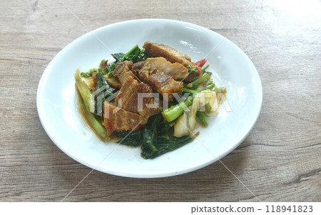 fried Chinese kale and cabbage with crispy pork in soy sauce on plate  118941823