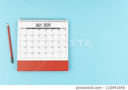 July desk calendar for 2025 year with pencil on blue background, Position with copy space. July desk calendar for 2025 year with pencil on blue background, Position with copy space. 118941840