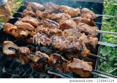 pork kebab is cooked on skewers on a fire pork kebab is cooked on skewers on a fire 118942124