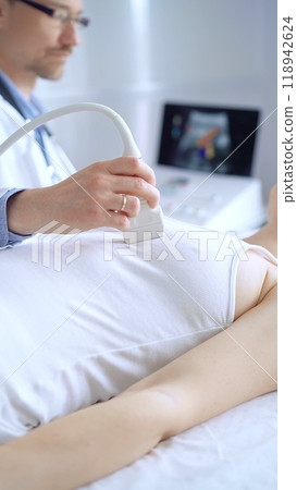 Doctor man using ultrasound equipment on the breast of a female patient. Mammary gland health. Medicine concept 118942624