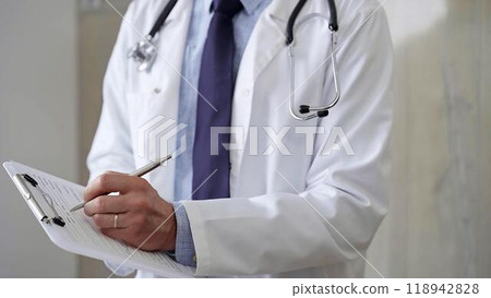Male doctor filling medical form on clipboard, writing prescription, making notes. Medicine and science 118942828