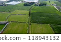 A stunning aerial view highlights vast green fields and organized farm infrastructure 118943132