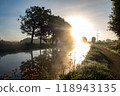 A Serene Sunrise Unfolds Over a Misty River Landscape, Creating a Beautiful Morning Scene 118943135