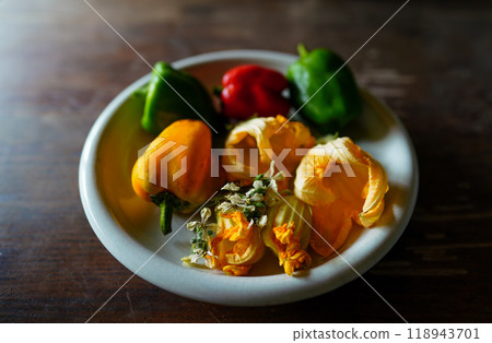 Pumpkin flowers and peppers on a plate 118943701