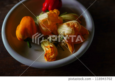 Pumpkin flowers and peppers on a table 118943702