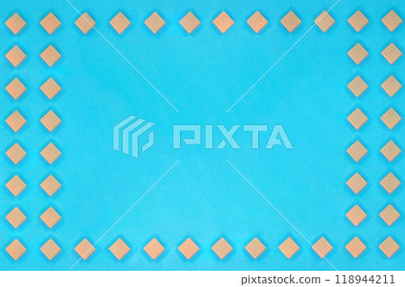 A square frame surrounded by aligned diamond-shaped blocks on a light blue background 118944211