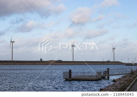 Wind turbine farm power genarator in beautiful nature landscape for production of renewable green energy. 118945043